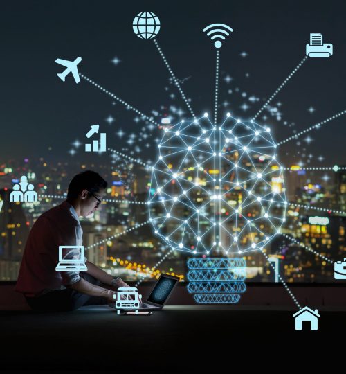 Polygonal brain shape of an artificial intelligence with various icon of smart city Internet of Things Technology over Asian businessman sitting and using the laptop over the cityscape background